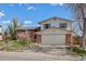 Charming two-story home featuring a brick facade, two-car garage and manicured front yard at 7140 S Reed Ct, Littleton, CO 80128