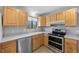 Updated kitchen with stainless steel dishwasher and modern appliances at 7140 S Reed Ct, Littleton, CO 80128