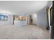 Open-concept living room with a dining area and a modern kitchen island at 7140 S Reed Ct, Littleton, CO 80128