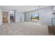 Finished basement living space with carpeting, walk-out access, and adjacent bathroom at 7140 S Reed Ct, Littleton, CO 80128