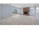 Bright living room features a brick fireplace, sliding glass doors, and neutral carpeting at 7140 S Reed Ct, Littleton, CO 80128