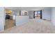 Spacious living room area with hardwood floors in kitchen, neutral walls and bright natural light at 7140 S Reed Ct, Littleton, CO 80128