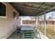A covered back porch with a table and chairs looking out on the yard at 1882 S Stuart St, Denver, CO 80219