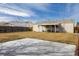 Private backyard featuring a concrete pad and covered patio, perfect for outdoor enjoyment and relaxation at 1882 S Stuart St, Denver, CO 80219