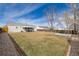 Expansive backyard with a concrete pad, perfect for outdoor activities, surrounded by a well-kept lawn at 1882 S Stuart St, Denver, CO 80219