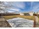 Backyard featuring a concrete pad, ideal for recreation, with a covered patio area and a lawn at 1882 S Stuart St, Denver, CO 80219