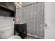 Bathroom with a toilet, sink, and black and white patterned shower curtain at 1882 S Stuart St, Denver, CO 80219