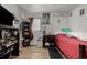 Bedroom with wood floors, a bed, desk and decorative Halloween decor at 1882 S Stuart St, Denver, CO 80219