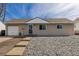 Charming single-story home featuring a gravel yard, and a one-car garage at 1882 S Stuart St, Denver, CO 80219