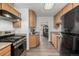 Well-lit kitchen featuring sleek stainless steel appliances, wood cabinets, and modern countertops at 1882 S Stuart St, Denver, CO 80219