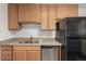 Kitchen featuring a stainless steel dishwasher, a double-basin sink, and durable countertops at 1882 S Stuart St, Denver, CO 80219