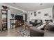 Well-lit living room with wood floors, comfortable seating, and a large mirror at 1882 S Stuart St, Denver, CO 80219
