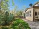 The home features a lawn with mature trees, lush foliage and a charming walkway to the patio at 41 Garner Ln, Erie, CO 80516