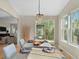 Sunlit dining area with table set, chandelier, and view to outdoor patio at 41 Garner Ln, Erie, CO 80516