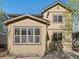 The exterior shows a tan-colored home with many windows to provide natural light, and a lush yard to enjoy at 41 Garner Ln, Erie, CO 80516