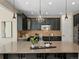Kitchen island with granite counters and dark cabinets and modern lighting at 41 Garner Ln, Erie, CO 80516