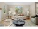 Bright living room with hardwood floors, neutral furniture, and natural light from a window at 41 Garner Ln, Erie, CO 80516
