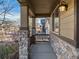 Inviting porch with stone columns and railings, offering a cozy outdoor space at 41 Garner Ln, Erie, CO 80516