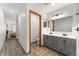Bathroom with double-sink vanity with gray cabinets, wood-look floors, and adjacent WC at 11705 W Stanford Ln, Morrison, CO 80465