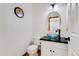 Stylish half-bathroom with unique glass bowl sink and modern fixtures at 11705 W Stanford Ln, Morrison, CO 80465