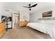 Bedroom with plush neutral carpet, wooden dresser, and white walls with decorative painting at 11705 W Stanford Ln, Morrison, CO 80465