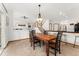 Open dining area with a rustic table, elegant chandelier, and stairway access at 11705 W Stanford Ln, Morrison, CO 80465