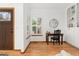 Bright entryway featuring hardwood floors, large window, and custom built-in shelving providing an inviting space at 11705 W Stanford Ln, Morrison, CO 80465