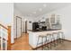 Modern kitchen with sleek black countertops, white cabinets, and breakfast bar seating at 11705 W Stanford Ln, Morrison, CO 80465