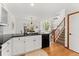 Kitchen with island and sink offers views to the living area and access to the stairs at 11705 W Stanford Ln, Morrison, CO 80465