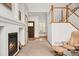 Open-concept living area featuring a fireplace and a staircase to the second floor, with ample natural light at 11705 W Stanford Ln, Morrison, CO 80465