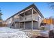 Home's backyard featuring a covered deck, patio, and yard with landscaping at 8217 W 71St Pl, Arvada, CO 80004