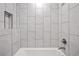 Bright bathroom with sleek white subway tiles and a built-in shower niche at 8217 W 71St Pl, Arvada, CO 80004