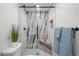 Sleek bathroom shower with marble-look tiling, glass enclosure, and modern fixtures for a spa-like experience at 8217 W 71St Pl, Arvada, CO 80004