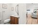 Chic powder room featuring modern fixtures and an adjoining view of the living space at 8217 W 71St Pl, Arvada, CO 80004