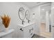 Tastefully designed bathroom with a double vanity, sleek black fixtures, and neutral decor at 8217 W 71St Pl, Arvada, CO 80004