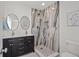 Modern bathroom with a dual sink vanity, marble shower, and beautiful fixtures at 8217 W 71St Pl, Arvada, CO 80004