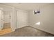 Carpeted bedroom featuring closet and doorway, offering storage and convenience at 8217 W 71St Pl, Arvada, CO 80004