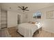 Bright bedroom featuring hardwood floors, a ceiling fan, and lots of natural light at 8217 W 71St Pl, Arvada, CO 80004