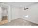 Cozy carpeted bedroom with closet and doorway to wood-floored hallway at 8217 W 71St Pl, Arvada, CO 80004