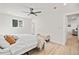 Bright bedroom featuring hardwood floors, a ceiling fan, and lots of natural light at 8217 W 71St Pl, Arvada, CO 80004