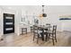 Bright dining area with wood floors and view of the modern kitchen at 8217 W 71St Pl, Arvada, CO 80004