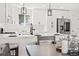 Bright modern kitchen with white cabinets, stainless steel appliances, and quartz countertops at 8217 W 71St Pl, Arvada, CO 80004