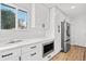 Bright kitchen featuring white cabinets, stainless steel appliances, and ample counter space at 8217 W 71St Pl, Arvada, CO 80004