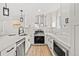 Well-lit kitchen with stainless steel appliances, white cabinetry, and a sleek design at 8217 W 71St Pl, Arvada, CO 80004