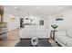 Bright living room featuring modern decor, wood flooring, and an open-concept design at 8217 W 71St Pl, Arvada, CO 80004