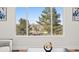 Living room view showcasing natural light and neighborhood scenery through a large window at 8217 W 71St Pl, Arvada, CO 80004