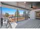 Inviting outdoor patio boasts scenic views, a ceiling fan, and ample space for entertaining guests at 8217 W 71St Pl, Arvada, CO 80004