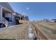 Landscaped backyard showing steps to a covered patio and privacy fence at 8760 Ginkgo Loop, Parker, CO 80134