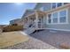 Exterior shows a covered patio, privacy fence, rock landscaping and lawn at 8760 Ginkgo Loop, Parker, CO 80134