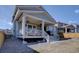 Rear exterior shows a deck with patio heaters and steps to the backyard at 8760 Ginkgo Loop, Parker, CO 80134